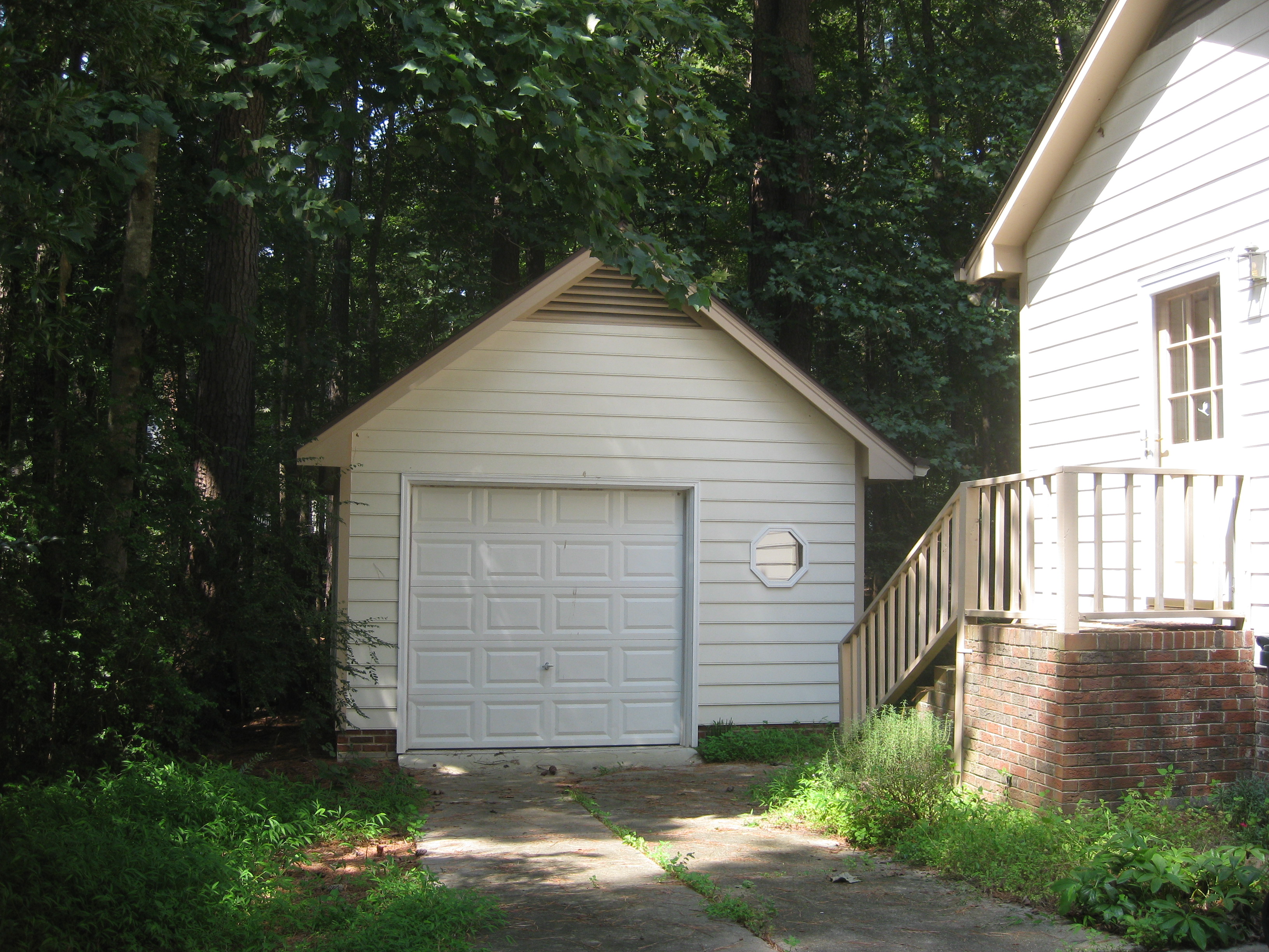 A garage standing next to a house.